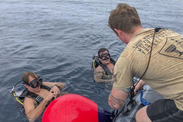 Navy EOD divers receiving instruction 